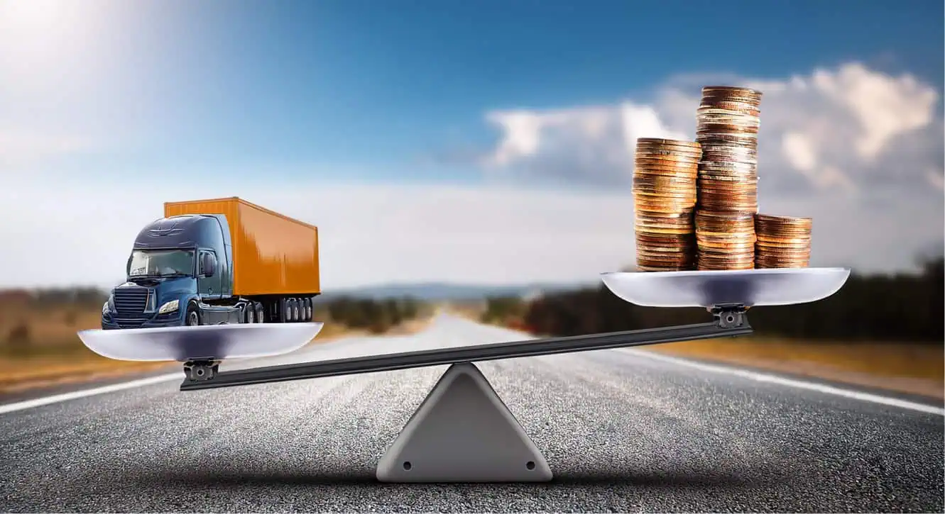 a scale holding a semi truck and gold coins to show balance