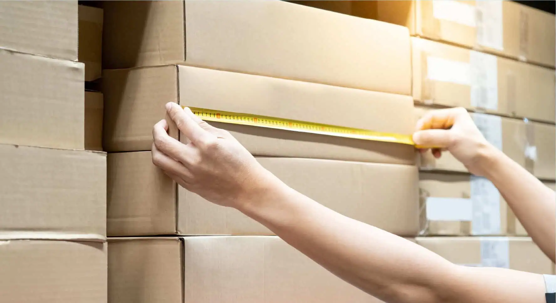 person measuring a parcel package dimension