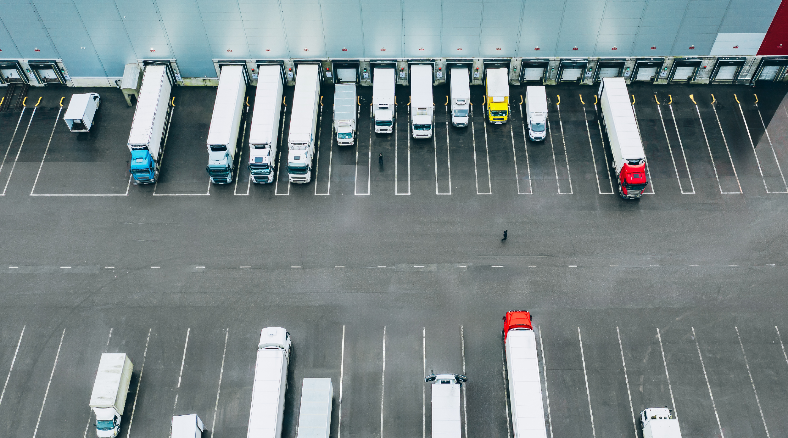 Different truck modes backed up to a loading dock