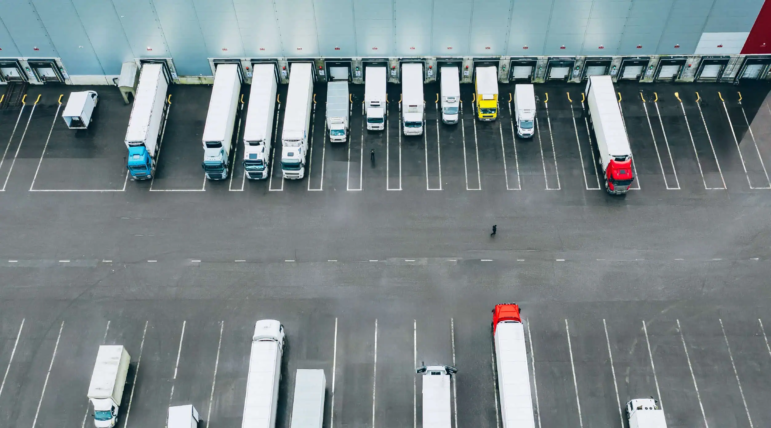 Different truck modes backed up to a loading dock