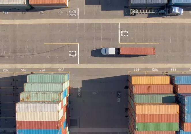 truck driving on a shipping yard
