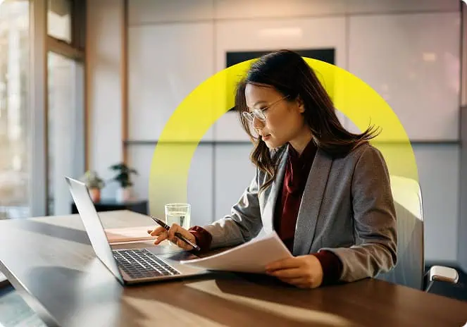 woman working on a laptop in office setting