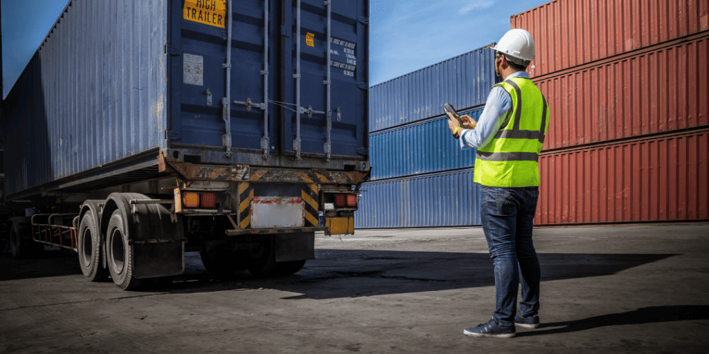 person looking at a drayage load at a container yard