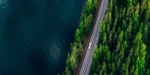Car on a highway next to a body of water