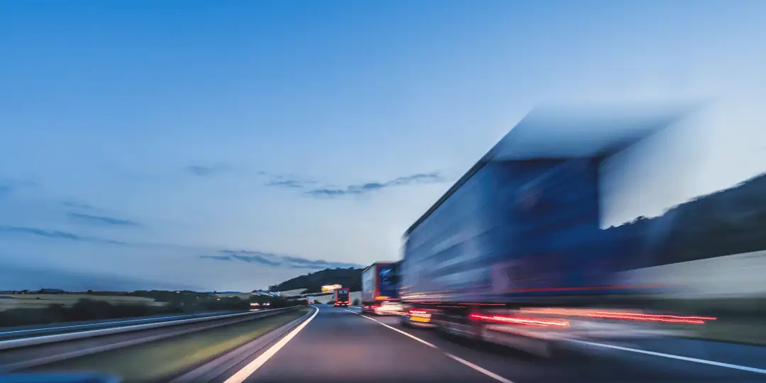 trucks driving on a highway - blurry image