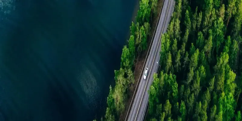 Car on a highway next to a body of water